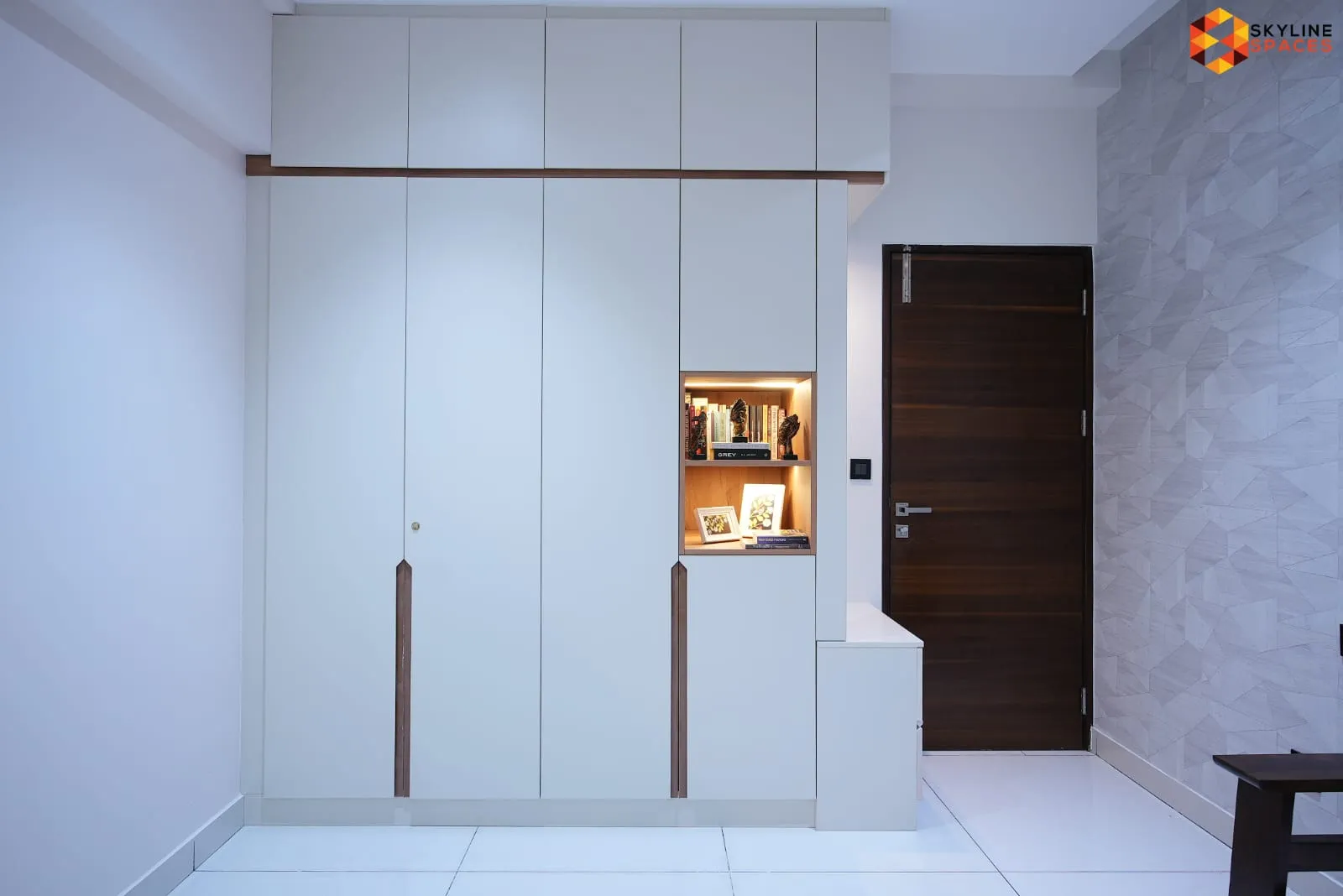 Signature tier wardrobe unit with bookshelf niche near entrance, Bangalore