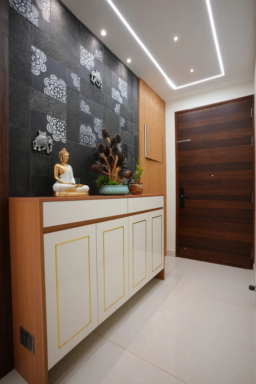 Signature tier foyer design with wooden console and Buddha decor, Bangalore